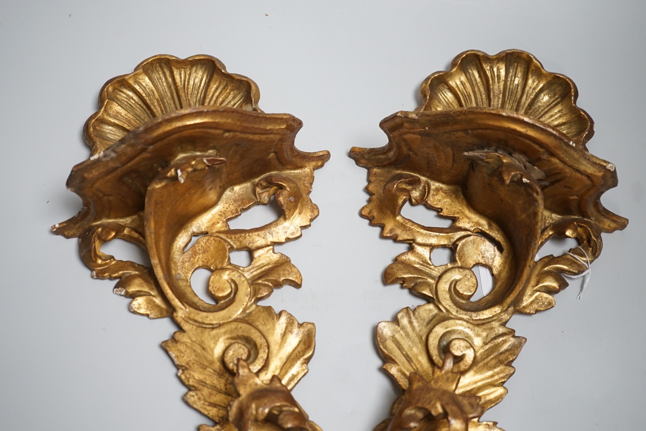 A pair of Italian gilt wood wall brackets in rococo style, early 20th century, 44cm long